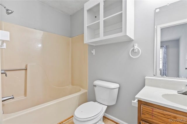 full bathroom featuring washtub / shower combination, baseboards, vanity, and toilet