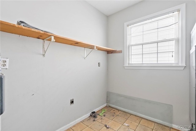 clothes washing area featuring laundry area, hookup for an electric dryer, and baseboards