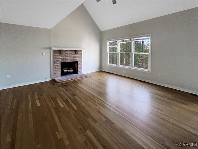 unfurnished living room with high vaulted ceiling, ceiling fan, baseboards, and wood finished floors