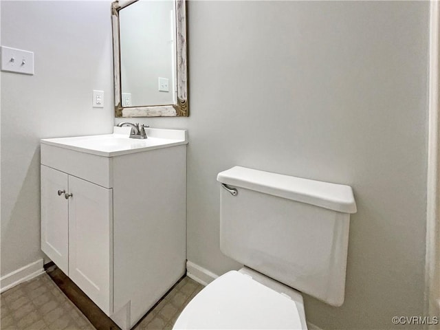 bathroom with tile patterned floors, vanity, toilet, and baseboards