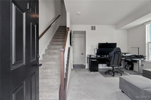 carpeted office space featuring visible vents