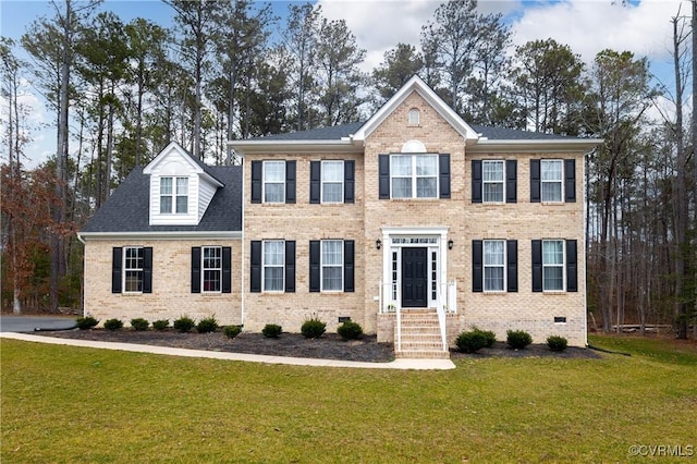 colonial home with a front lawn, crawl space, and brick siding