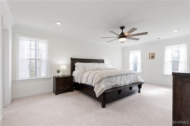 bedroom with baseboards, ceiling fan, ornamental molding, and light colored carpet