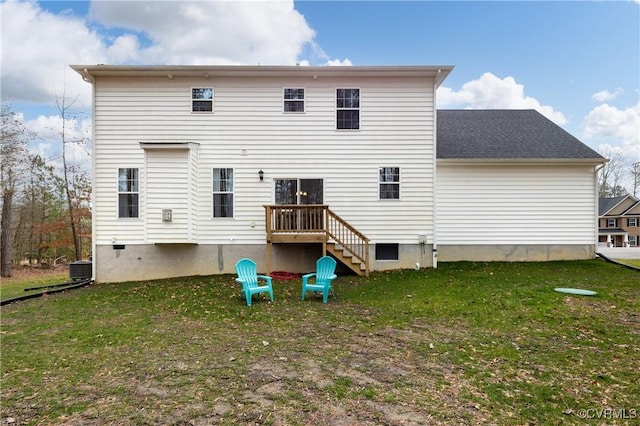 rear view of house with central AC and a lawn