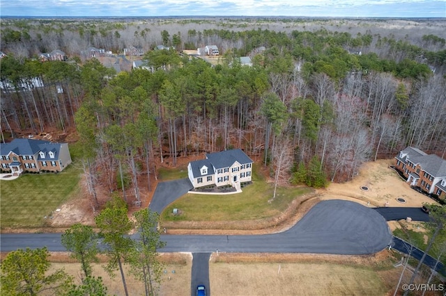 birds eye view of property with a wooded view