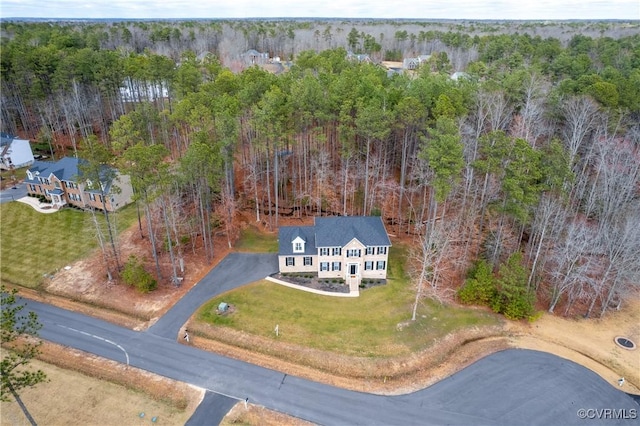 birds eye view of property with a wooded view