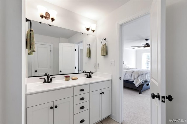 bathroom featuring ceiling fan, double vanity, a sink, and ensuite bathroom