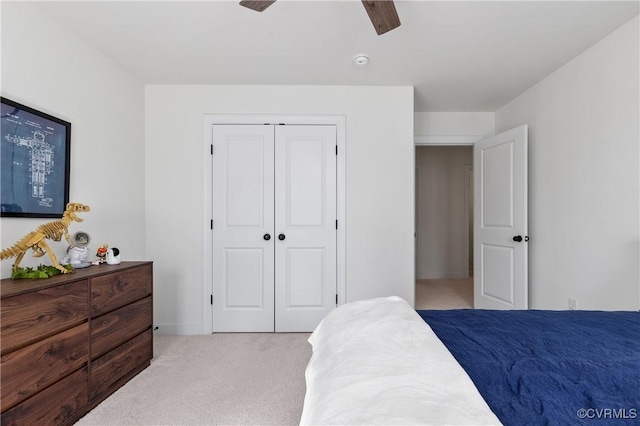 carpeted bedroom with a closet and a ceiling fan