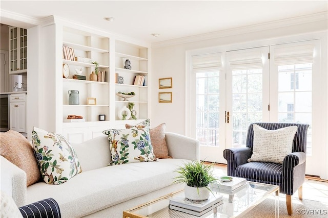 sitting room featuring french doors, built in shelves, beverage cooler, and crown molding