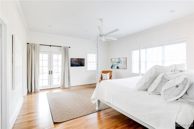 bedroom with french doors, baseboards, light wood finished floors, and ornamental molding