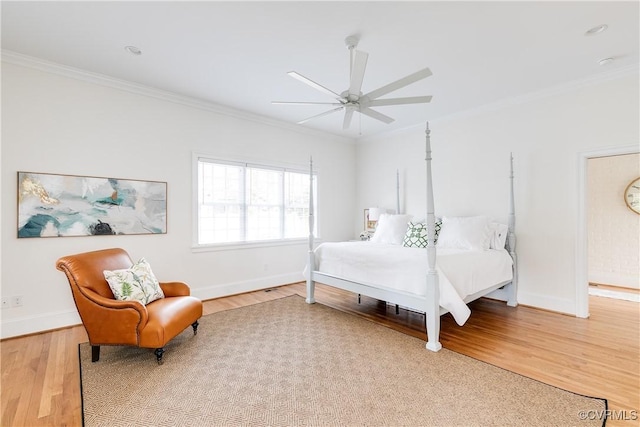 bedroom featuring light wood-style flooring, a ceiling fan, crown molding, and baseboards