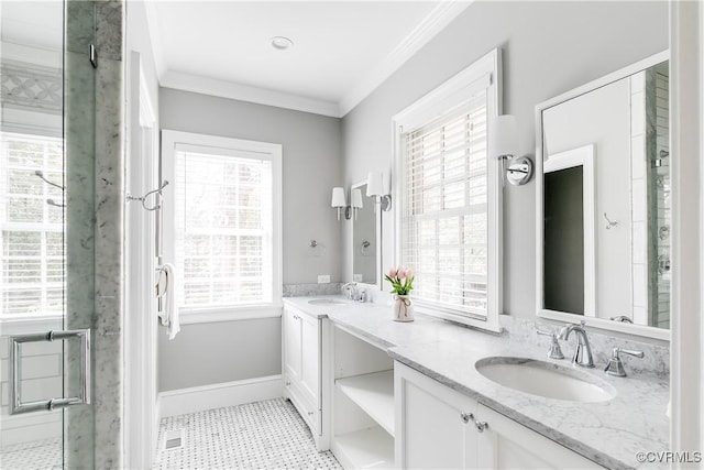 full bath with crown molding, double vanity, baseboards, and a sink