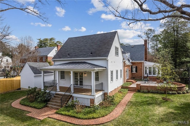 rear view of house with a patio, fence, a porch, a yard, and french doors