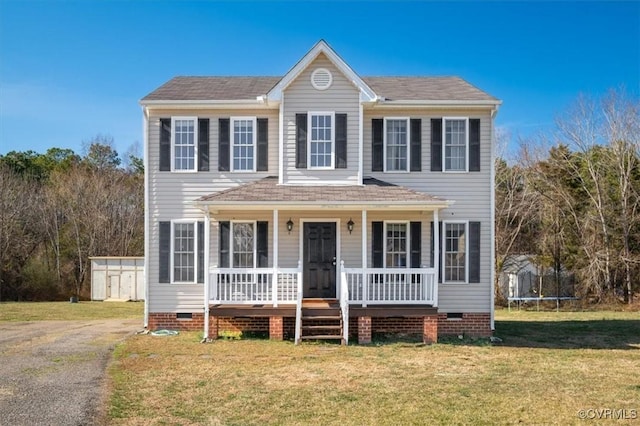 view of front facade featuring a trampoline, crawl space, covered porch, and a front lawn