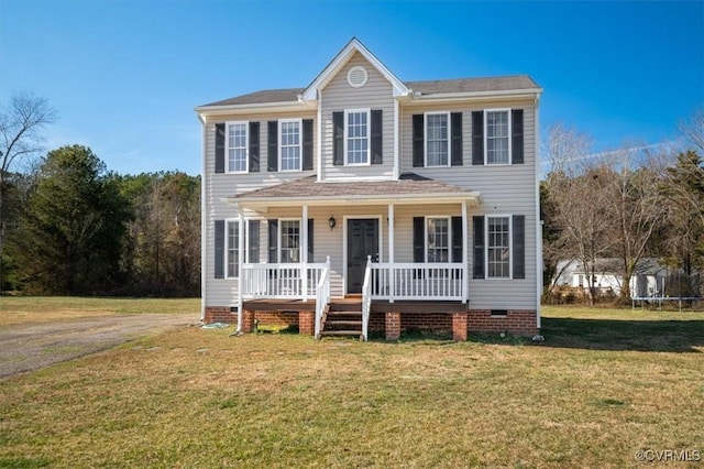 colonial home with crawl space, a trampoline, a front lawn, and a porch