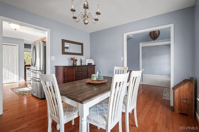 dining room featuring a notable chandelier and wood finished floors