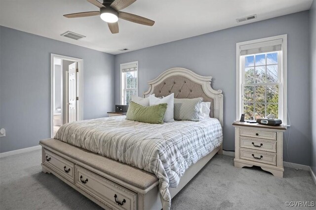 carpeted bedroom featuring baseboards, visible vents, and a ceiling fan