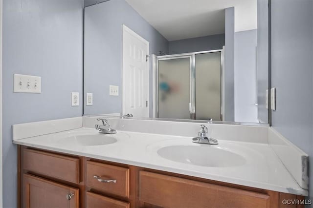 full bath featuring double vanity, a stall shower, and a sink