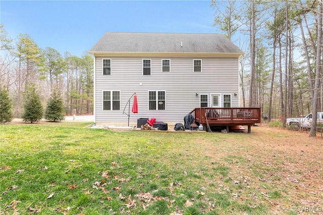 back of property featuring a yard and a wooden deck