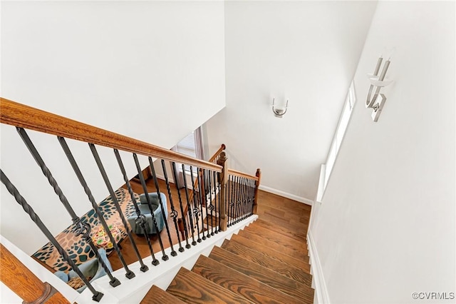 stairs with baseboards and wood finished floors