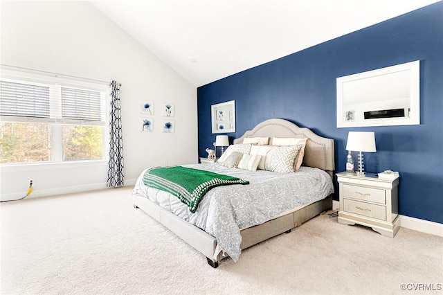 carpeted bedroom featuring lofted ceiling and baseboards