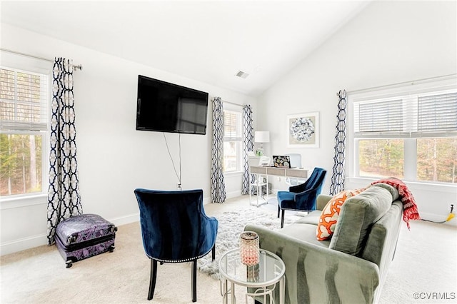 sitting room featuring lofted ceiling, carpet flooring, visible vents, and baseboards