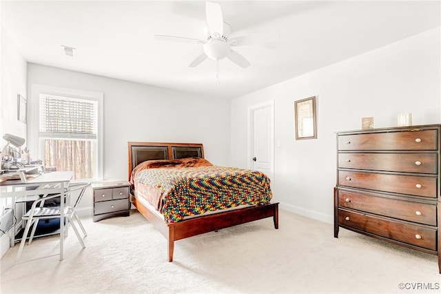 bedroom featuring baseboards, ceiling fan, visible vents, and light colored carpet