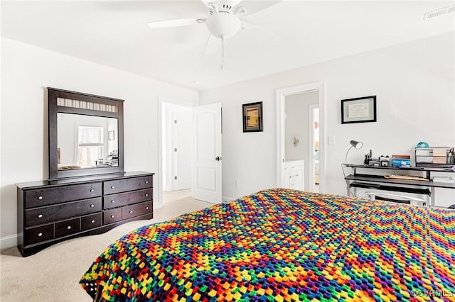 carpeted bedroom featuring a ceiling fan, visible vents, and connected bathroom