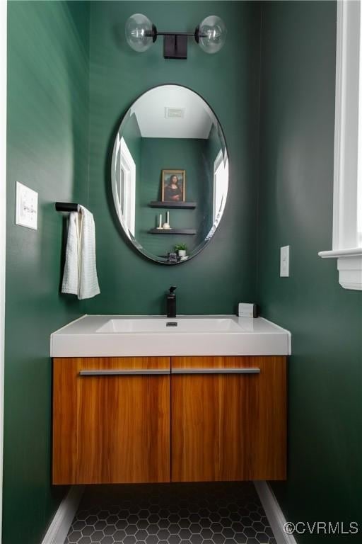 bathroom with vanity and baseboards