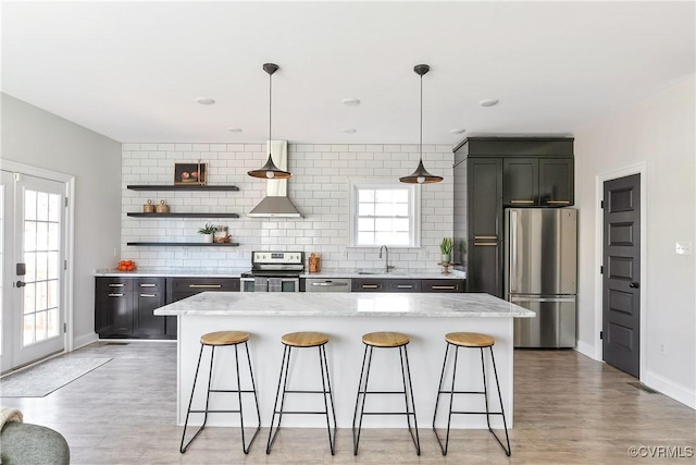 kitchen with stainless steel appliances, french doors, backsplash, and a breakfast bar area