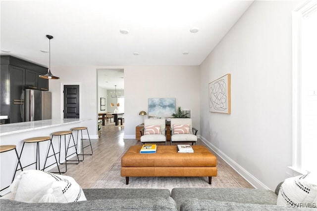 living room featuring light wood-type flooring and baseboards