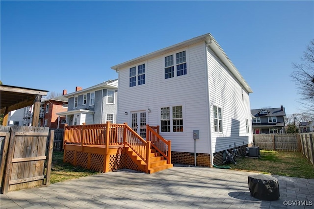 back of property with central AC unit, french doors, a patio, a fenced backyard, and a wooden deck