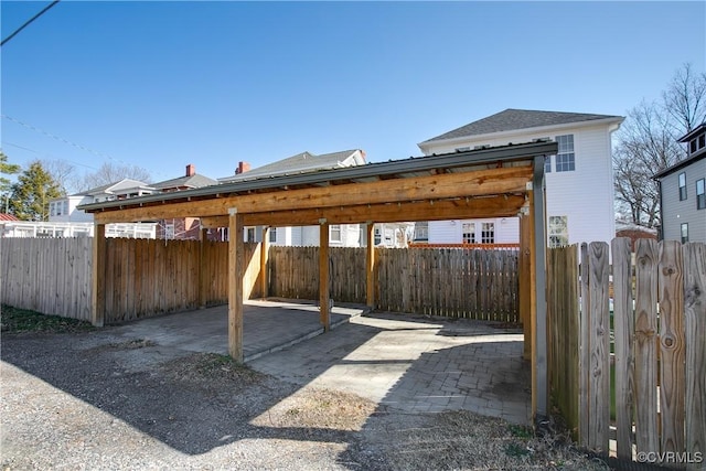 view of vehicle parking with fence