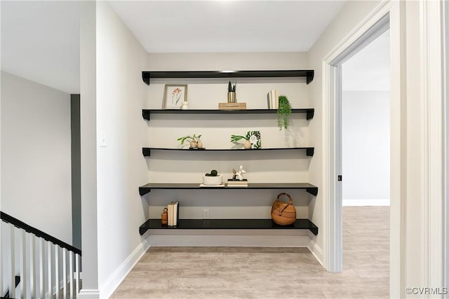 interior space with wood finished floors and baseboards