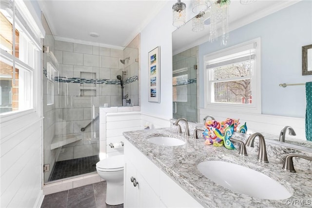 full bath with a wealth of natural light, a sink, and a shower stall