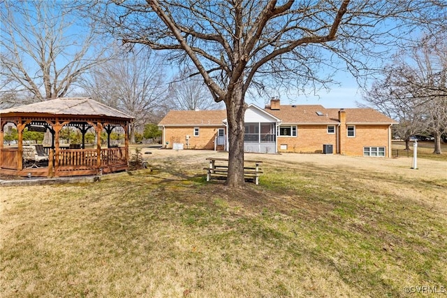 view of yard with a gazebo and a sunroom