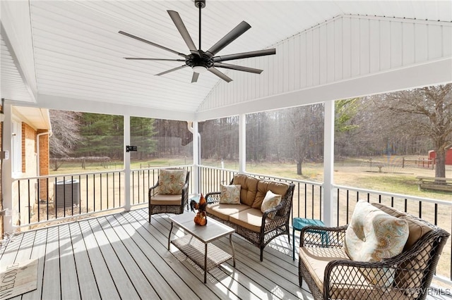 sunroom with lofted ceiling and ceiling fan