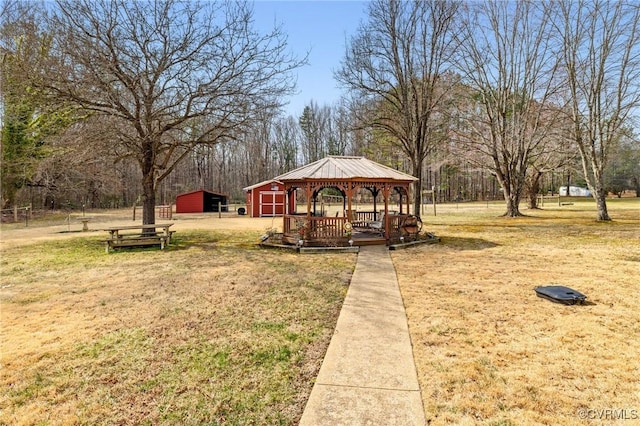 view of yard with an outdoor structure, a detached garage, and a gazebo