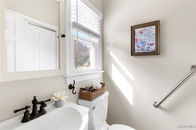 half bathroom featuring a sink and toilet