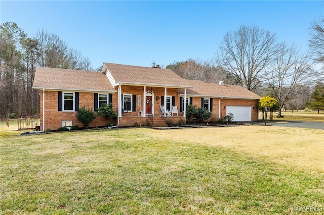 ranch-style home with an attached garage, a front yard, a porch, and brick siding