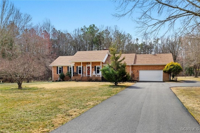 view of front of property featuring driveway, brick siding, an attached garage, a porch, and a front yard