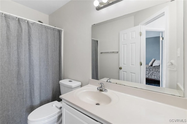 full bath featuring curtained shower, vanity, and toilet