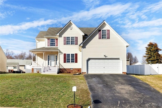 traditional-style house with an attached garage, fence, driveway, crawl space, and a front yard