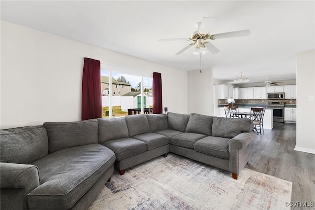 living area with ceiling fan and wood finished floors