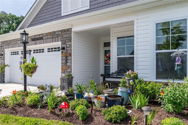 property entrance with stone siding and concrete driveway