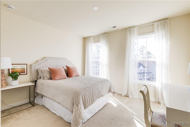 bedroom featuring light carpet, baseboards, and visible vents