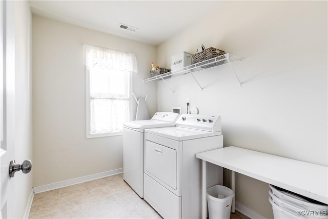 laundry room featuring laundry area, light tile patterned floors, baseboards, visible vents, and separate washer and dryer