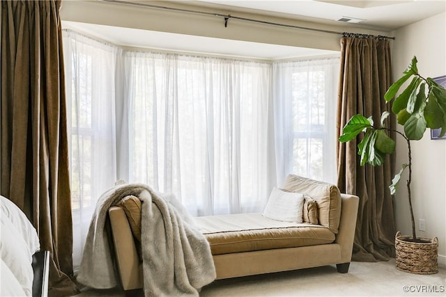 living area featuring visible vents and a wealth of natural light