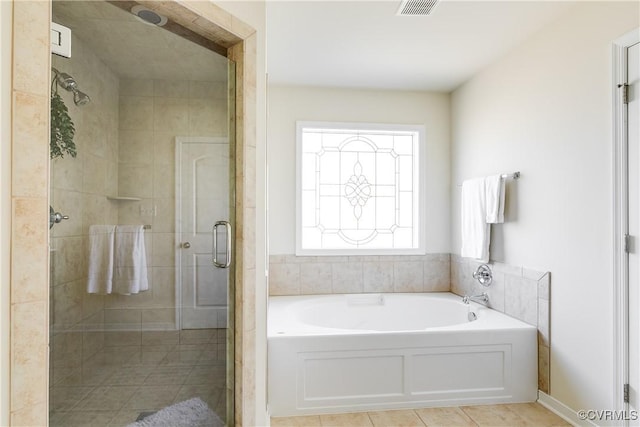 bathroom featuring a stall shower, tile patterned flooring, visible vents, and a bath