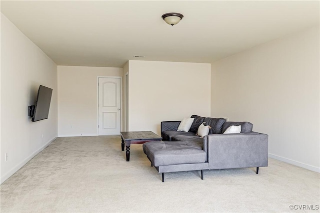 living area featuring light carpet and baseboards